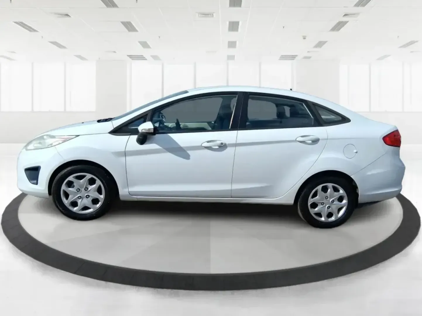 2013 Ford Fiesta SE (3FADP4BJXDM) with an 1.6L I-4 DOHC engine, located at 1951 S Dayton Lakeview Rd., New Carlisle, OH, 45344, (937) 908-9800, 39.890999, -84.050255 - Need a smart, efficient commuter that's easy to park downtown, nimble on I70, and still comfortable for weekend errands or a quick getaway to Springfield or Dayton? This 2013 Ford Fiesta SE Sedan in Oxford White delivers practical daily driving with the kind of budget-friendly ownership that fits re - Photo#5