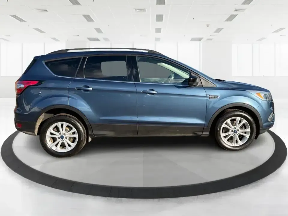 2018 Ford Escape SE (1FMCU9GD4JU) with an 1.5L L4 DOHC 16V engine, 6A transmission, located at 880 E. National Road, Vandalia, OH, 45377, (937) 908-9800, 39.891918, -84.183594 - Picture your next Ohio weekend: loading up the kids for a splash at Splash Xenia, cruising out to John Bryan State Park for a hike, or tackling a snowy morning commute from Beavercreek to downtown Dayton with confidence. This 2018 Ford Escape SE in Blue Metallic is the kind of compact SUV that fits - Photo#1
