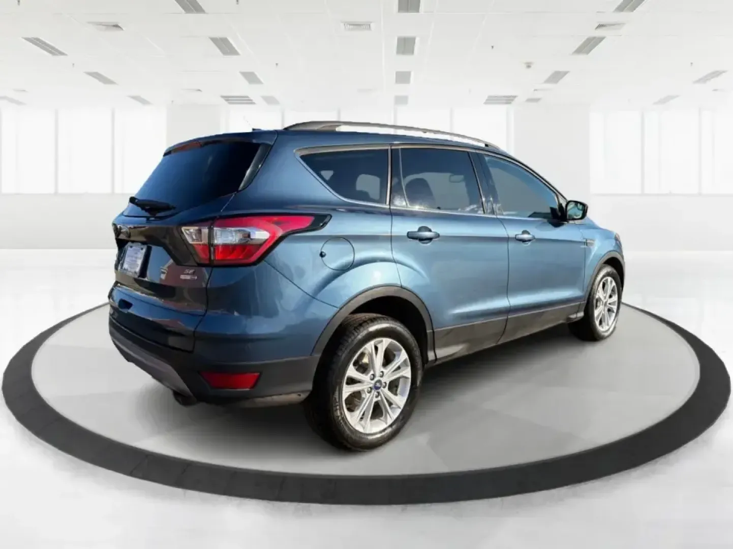 2018 Ford Escape SE (1FMCU9GD4JU) with an 1.5L L4 DOHC 16V engine, 6A transmission, located at 880 E. National Road, Vandalia, OH, 45377, (937) 908-9800, 39.891918, -84.183594 - Picture your next Ohio weekend: loading up the kids for a splash at Splash Xenia, cruising out to John Bryan State Park for a hike, or tackling a snowy morning commute from Beavercreek to downtown Dayton with confidence. This 2018 Ford Escape SE in Blue Metallic is the kind of compact SUV that fits - Photo#2
