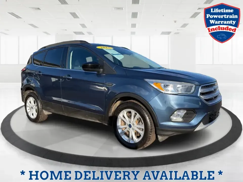 2018 Ford Escape SE (1FMCU9GD4JU) with an 1.5L L4 DOHC 16V engine, 6A transmission, located at 880 E. National Road, Vandalia, OH, 45377, (937) 908-9800, 39.891918, -84.183594 - Picture your next Ohio weekend: loading up the kids for a splash at Splash Xenia, cruising out to John Bryan State Park for a hike, or tackling a snowy morning commute from Beavercreek to downtown Dayton with confidence. This 2018 Ford Escape SE in Blue Metallic is the kind of compact SUV that fits - Photo#0
