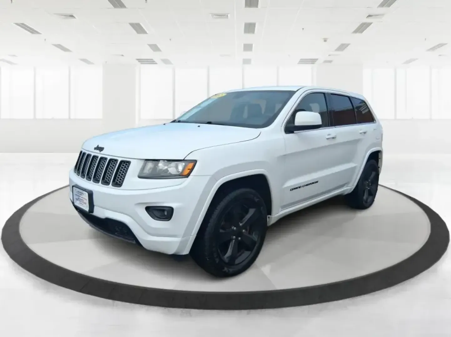 2015 Jeep Grand Cherokee Altitude (1C4RJFAG9FC) with an 3.6L V-6 DOHC engine, 8-Speed Automatic transmission, located at 1099 N County Rd 25A, Troy, OH, 45373, (937) 908-9800, 40.057079, -84.212883 - Weekend getaways to Hocking Hills, snowy school runs, or a confident daily commute up I75 feel easier when your SUV is built for real Ohio weather and real-life schedules. This 2015 Jeep Grand Cherokee Altitude in Bright White Clearcoat is the kind of capable, comfortable SUV that fits busy families - Photo#8