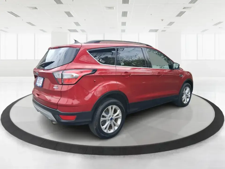 2018 Ford Escape SEL (1FMCU9HD2JU) with an 1.5L L4 DOHC 16V engine, 6A transmission, located at 4508 South Dixie Dr, Moraine, OH, 45439, (937) 908-9800, 39.689976, -84.218452 - Need a do-it-all SUV that can handle the weekday commute on I-675, quick school drop-offs near Wright-Patterson AFB, and spontaneous weekend getaways to Carillon Historical Park or a lap around Eastwood MetroPark? This 2018 Ford Escape SEL in Ruby Red Metallic Tinted Clearcoat is built for real-life - Photo#2