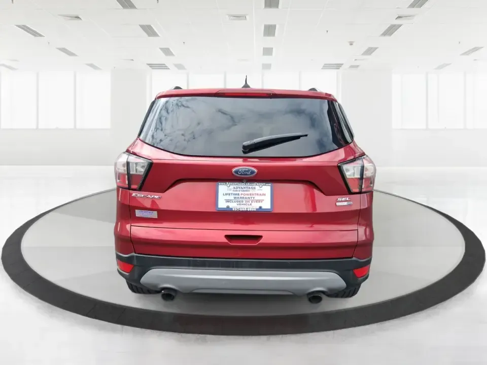 2018 Ford Escape SEL (1FMCU9HD2JU) with an 1.5L L4 DOHC 16V engine, 6A transmission, located at 4508 South Dixie Dr, Moraine, OH, 45439, (937) 908-9800, 39.689976, -84.218452 - Need a do-it-all SUV that can handle the weekday commute on I-675, quick school drop-offs near Wright-Patterson AFB, and spontaneous weekend getaways to Carillon Historical Park or a lap around Eastwood MetroPark? This 2018 Ford Escape SEL in Ruby Red Metallic Tinted Clearcoat is built for real-life - Photo#3