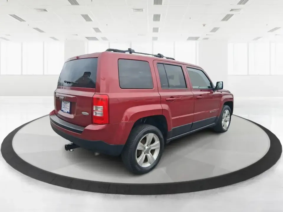 2014 Jeep Patriot Latitude 2WD (1C4NJPFB3ED) with an 2.4L L4 DOHC 16V engine, located at 8750 N County Rd 25A, Piqua, OH, 45356, (937) 908-9800, 40.164391, -84.232513 - Picture a weekday commute down I70 followed by a Saturday escape to parks and backroads around Clark County-this 2014 Jeep Patriot Latitude is the kind of compact SUV that fits both routines without feeling oversized. Finished in Deep Cherry Red Crystal Pearlcoat and showing 90,565 miles, it's a pra - Photo#2