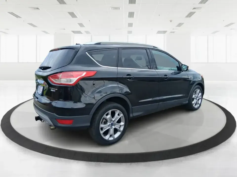 2014 Ford Escape Titanium (1FMCU9J99EU) with an 2.0L L4 DOHC 16V engine, 6-Speed Automatic transmission, located at 1099 N County Rd 25A, Troy, OH, 45373, (937) 908-9800, 40.057079, -84.212883 - Need one SUV that can handle an Ohio winter commute, school drop-offs, and a spontaneous weekend road trip to Hocking Hills without feeling like a compromise? This 2014 Ford Escape Titanium 4WD in sleek Tuxedo Black is built for real life in Troy-comfortable for long drives, confident in bad weather - Photo#2