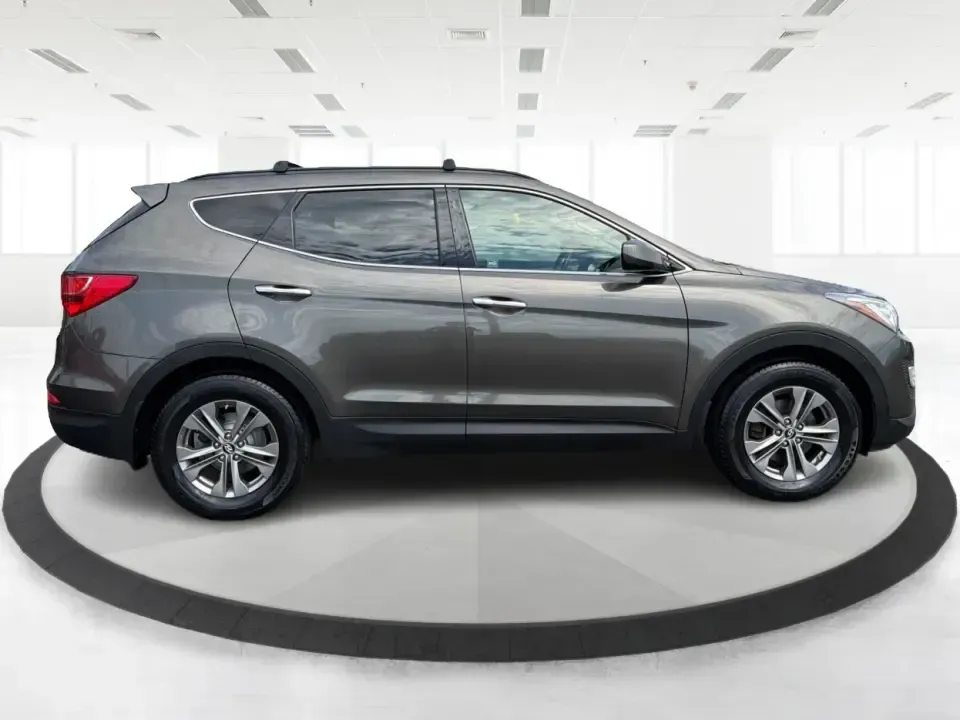 2014 Hyundai Santa Fe 2.4L (5XYZUDLB0EG) with an Theta II 2.4L I-4 gasoline direct injection engine, 6-Speed Automatic transmission, located at 4508 South Dixie Dr, Moraine, OH, 45439, (937) 908-9800, 39.689976, -84.218452 - Weekend road trips to Carillon Historical Park, snowy school-drop mornings, and everyday commuting down I75 or South Dixie Drive feel a lot easier when you've got a roomy SUV with confident traction and family-friendly comfort. This **2014 Hyundai Santa Fe 2.4L** in eye-catching **Cabo Bronze** is b - Photo#1